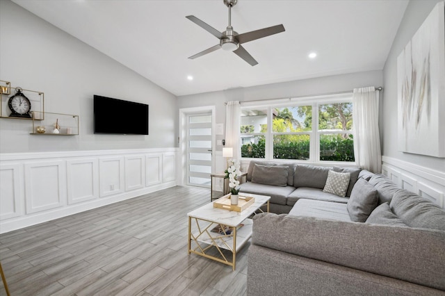 living room with vaulted ceiling, ceiling fan, and hardwood / wood-style flooring