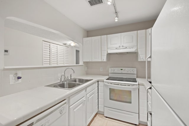 kitchen featuring sink, tasteful backsplash, tile countertops, white appliances, and white cabinets