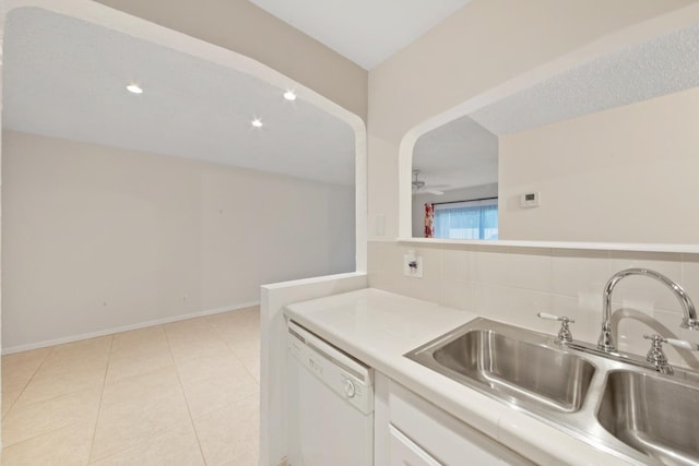 kitchen with sink, white dishwasher, ceiling fan, decorative backsplash, and white cabinets