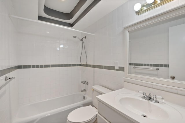 full bathroom with tile walls, tiled shower / bath combo, vanity, decorative backsplash, and toilet