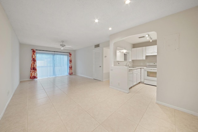 kitchen featuring light tile patterned floors, white appliances, ceiling fan, white cabinetry, and a textured ceiling