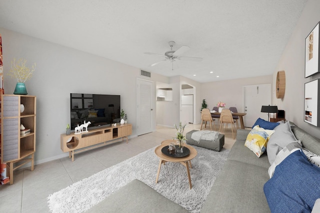 living room with ceiling fan and light tile patterned flooring