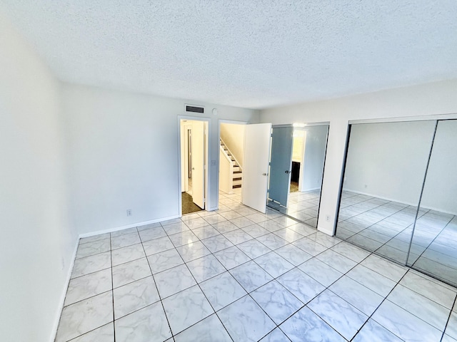 interior space featuring a closet and a textured ceiling