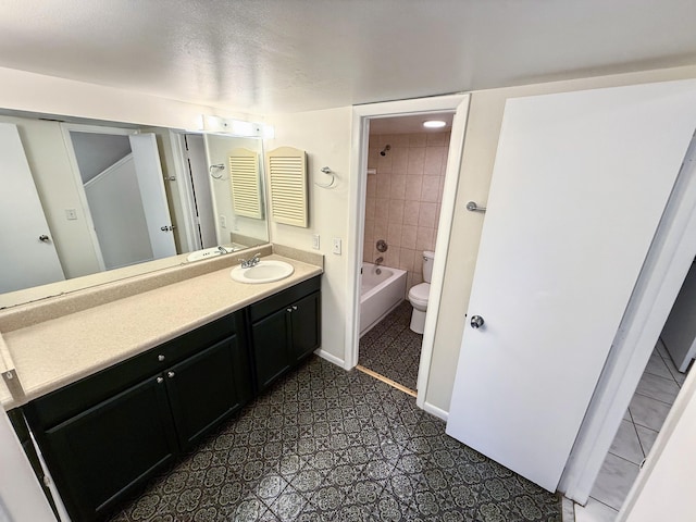 full bathroom featuring vanity, toilet, and tiled shower / bath combo