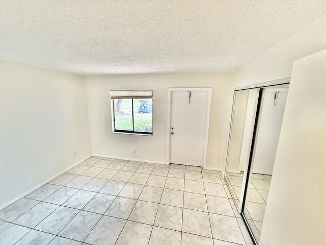 spare room featuring a textured ceiling