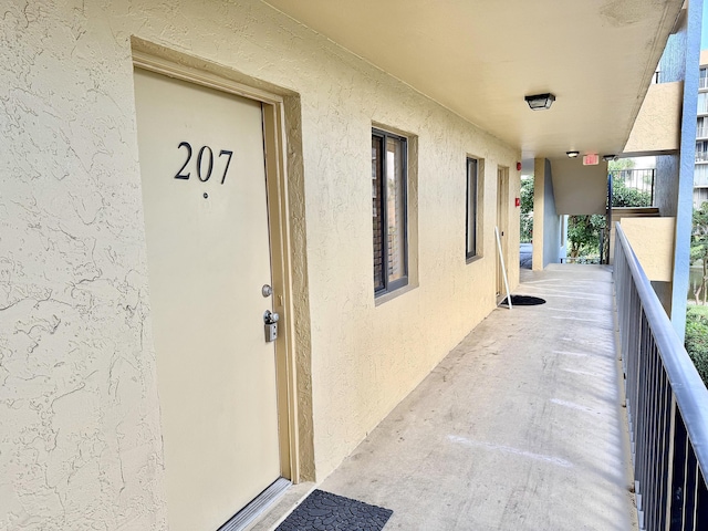 entrance to property featuring a balcony