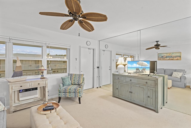 living room with light carpet, a wall mounted AC, and ceiling fan