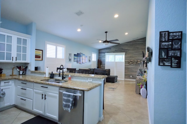 kitchen with kitchen peninsula, white cabinets, dishwasher, and sink