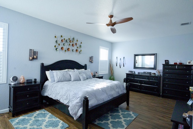 bedroom featuring ceiling fan and dark wood-type flooring