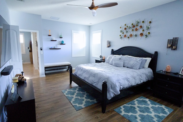 bedroom with ceiling fan and dark hardwood / wood-style flooring