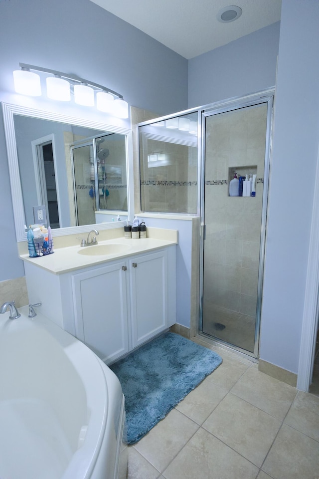 bathroom with tile patterned flooring, vanity, and independent shower and bath