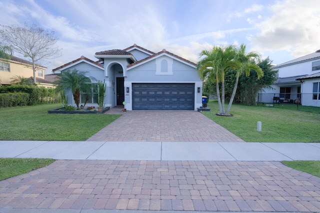 view of front of property with a garage and a front yard