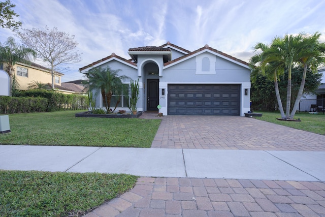 view of front of property with a garage and a front yard