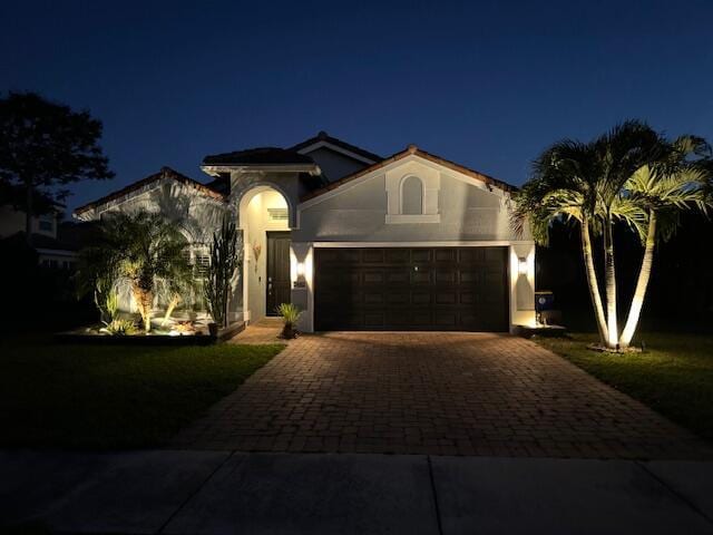 mediterranean / spanish-style home featuring a garage