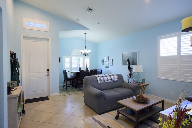 living room with light tile patterned floors, a chandelier, and lofted ceiling