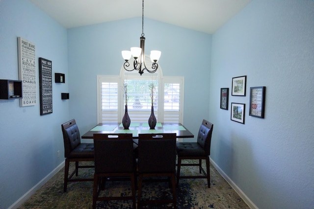 dining area featuring high vaulted ceiling and a notable chandelier