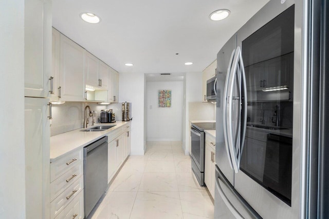 kitchen with tasteful backsplash, sink, white cabinets, and stainless steel appliances