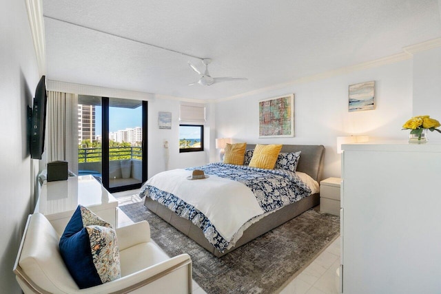 tiled bedroom featuring access to exterior, a textured ceiling, ceiling fan, and ornamental molding