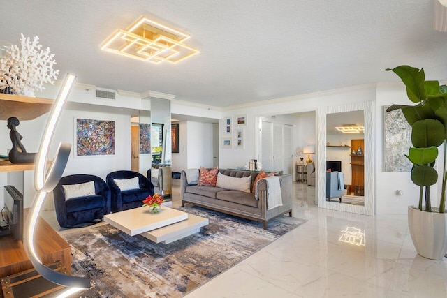 living room with ornamental molding and a textured ceiling