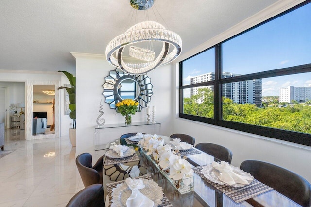 dining room featuring a notable chandelier and ornamental molding