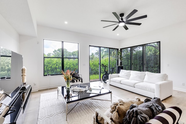 living room featuring ceiling fan and light hardwood / wood-style flooring