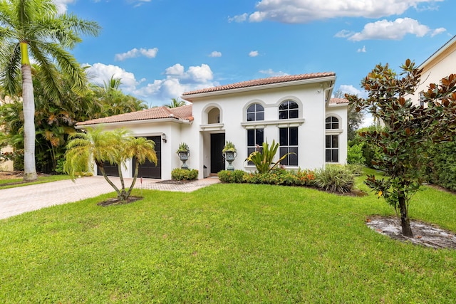 mediterranean / spanish house featuring a front lawn