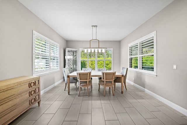 dining area featuring an inviting chandelier and a wealth of natural light