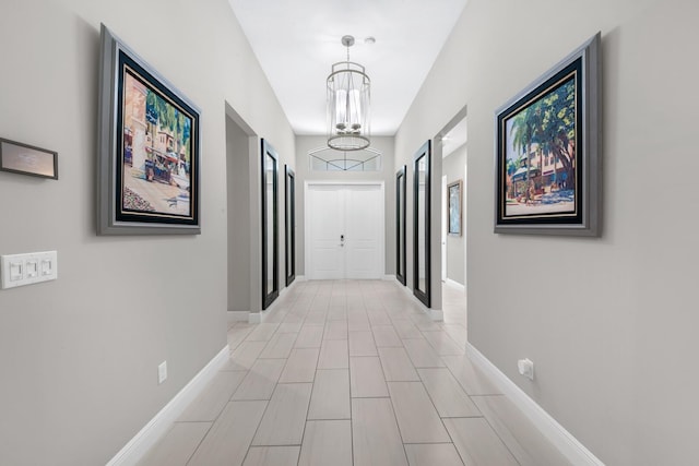 corridor featuring an inviting chandelier