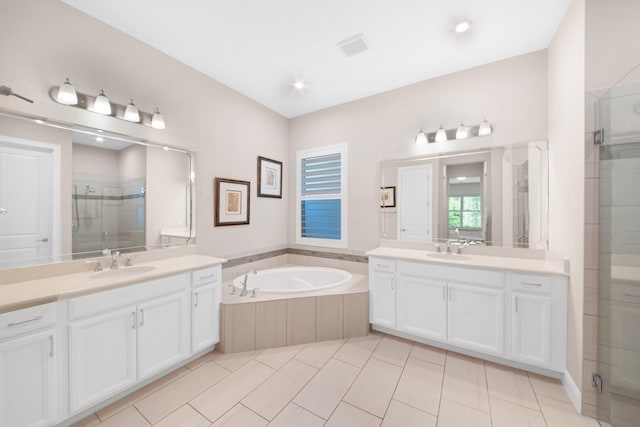 bathroom with tile patterned floors, vanity, and independent shower and bath