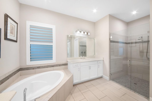 bathroom with tile patterned flooring, vanity, and separate shower and tub