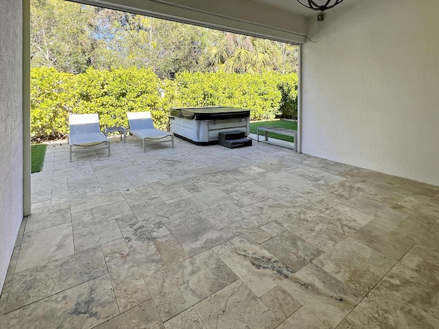 view of patio / terrace with a hot tub