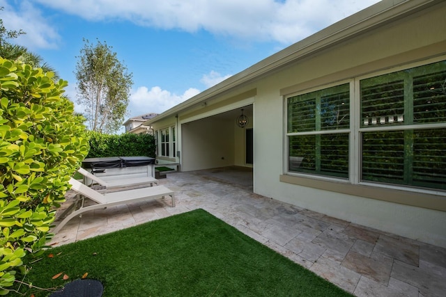 view of yard featuring a patio and a hot tub