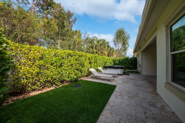 view of yard featuring a patio and a hot tub