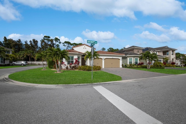 mediterranean / spanish house with a front yard and a garage