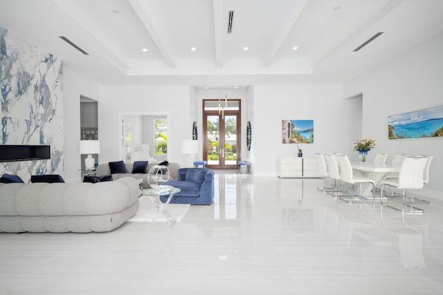 living room with beam ceiling and french doors