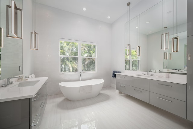 bathroom with tile patterned floors, vanity, tile walls, and independent shower and bath