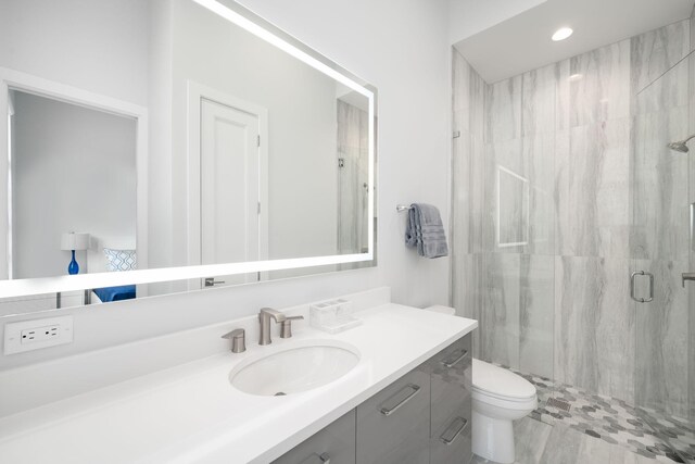 bathroom featuring vanity, toilet, and an enclosed shower