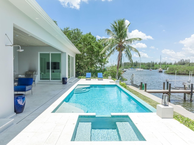 view of swimming pool featuring an in ground hot tub, a water view, and a patio