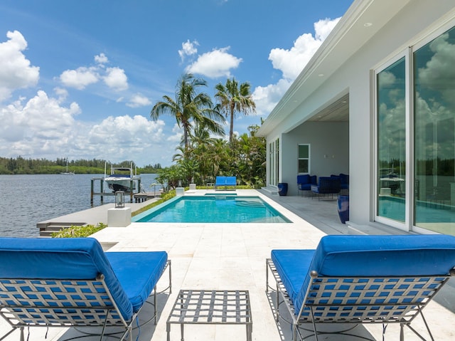 view of pool with a dock, a water view, a patio, and an outdoor hangout area