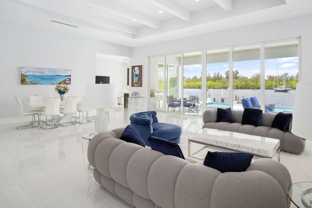 living room with beamed ceiling and a water view