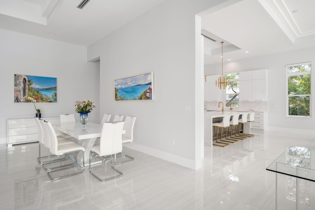 dining space featuring sink and a chandelier