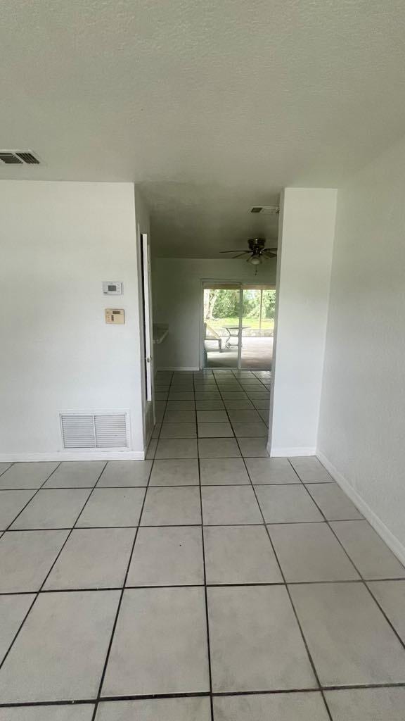 corridor with light tile patterned floors