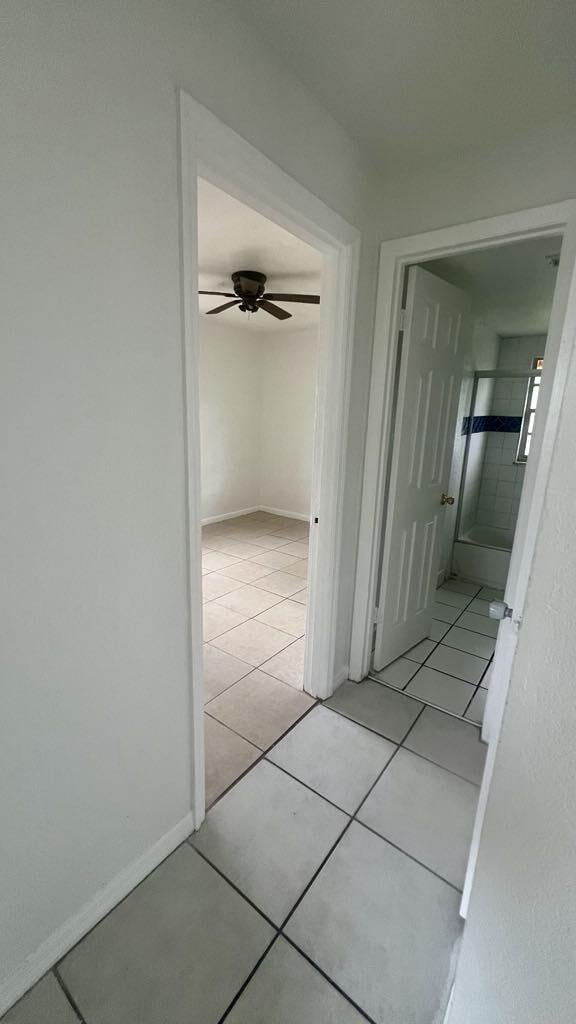 hall featuring light tile patterned floors