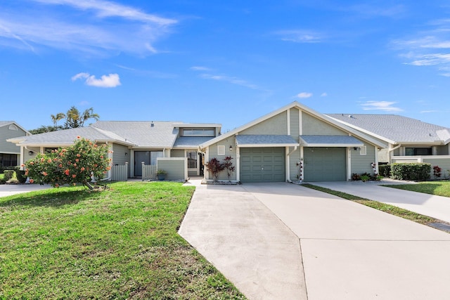 ranch-style house featuring a front yard and a garage