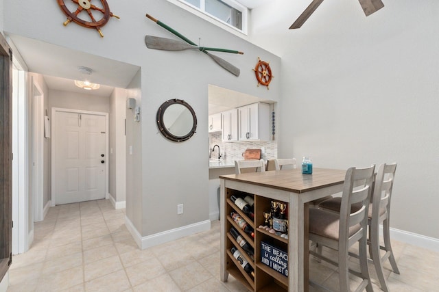 dining area with ceiling fan and light tile patterned floors