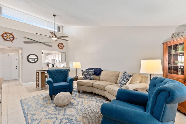 tiled living room with sink, high vaulted ceiling, and ceiling fan