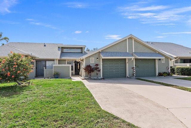 view of front of property featuring a garage and a front yard