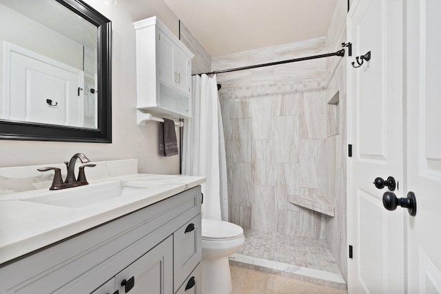 bathroom featuring vanity, toilet, tile patterned floors, and walk in shower