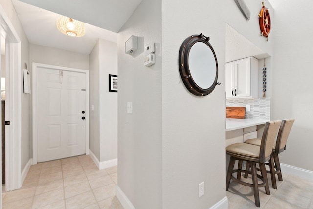 entryway with light tile patterned floors