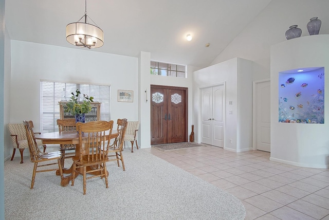 tiled dining space with high vaulted ceiling and an inviting chandelier